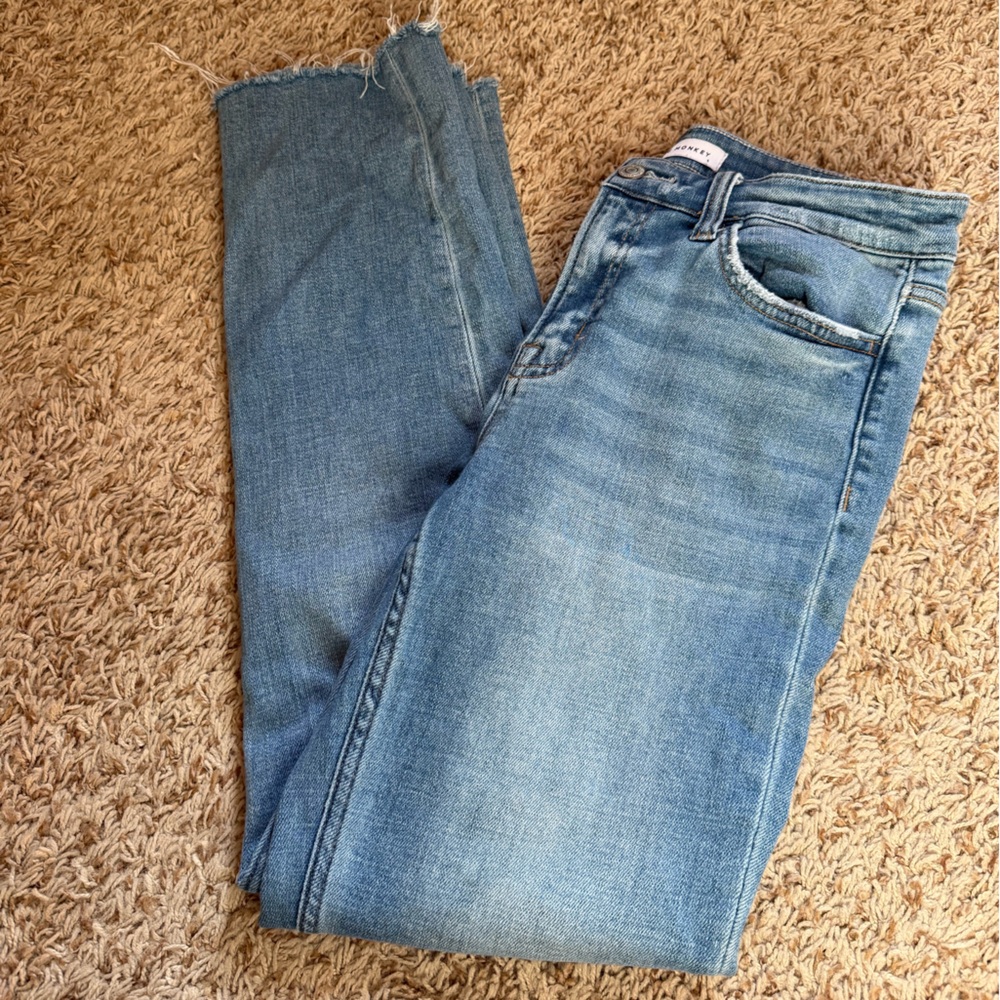 Flying monkey denim in light wash size 28. Light distressing on pockets. Raw hem